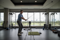 Executive golfer doing rotational power training