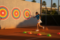Young tennis player practicing with target wall decals